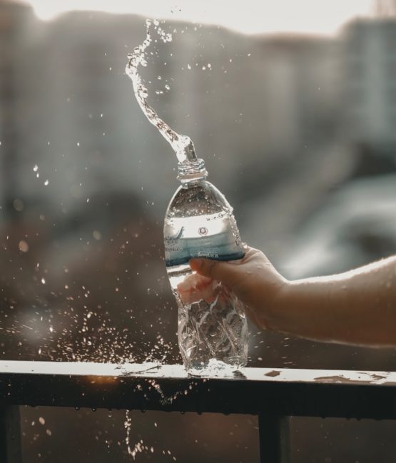 white and blue labeled disposable bottled water